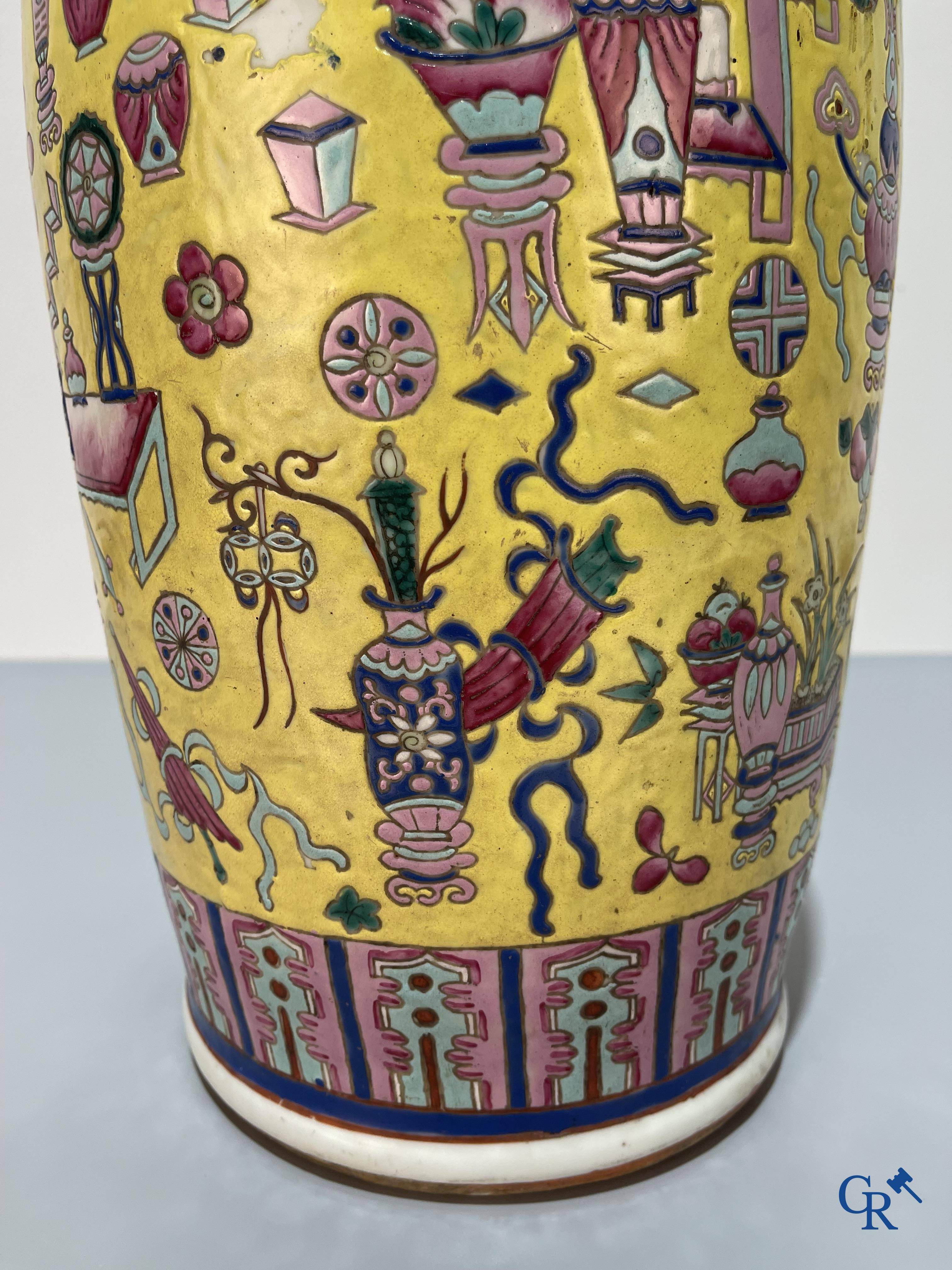 Asian Art, Chinese porcelain, a large Chinese famille jaune and rose vase with a decor of antiques. 19th century.