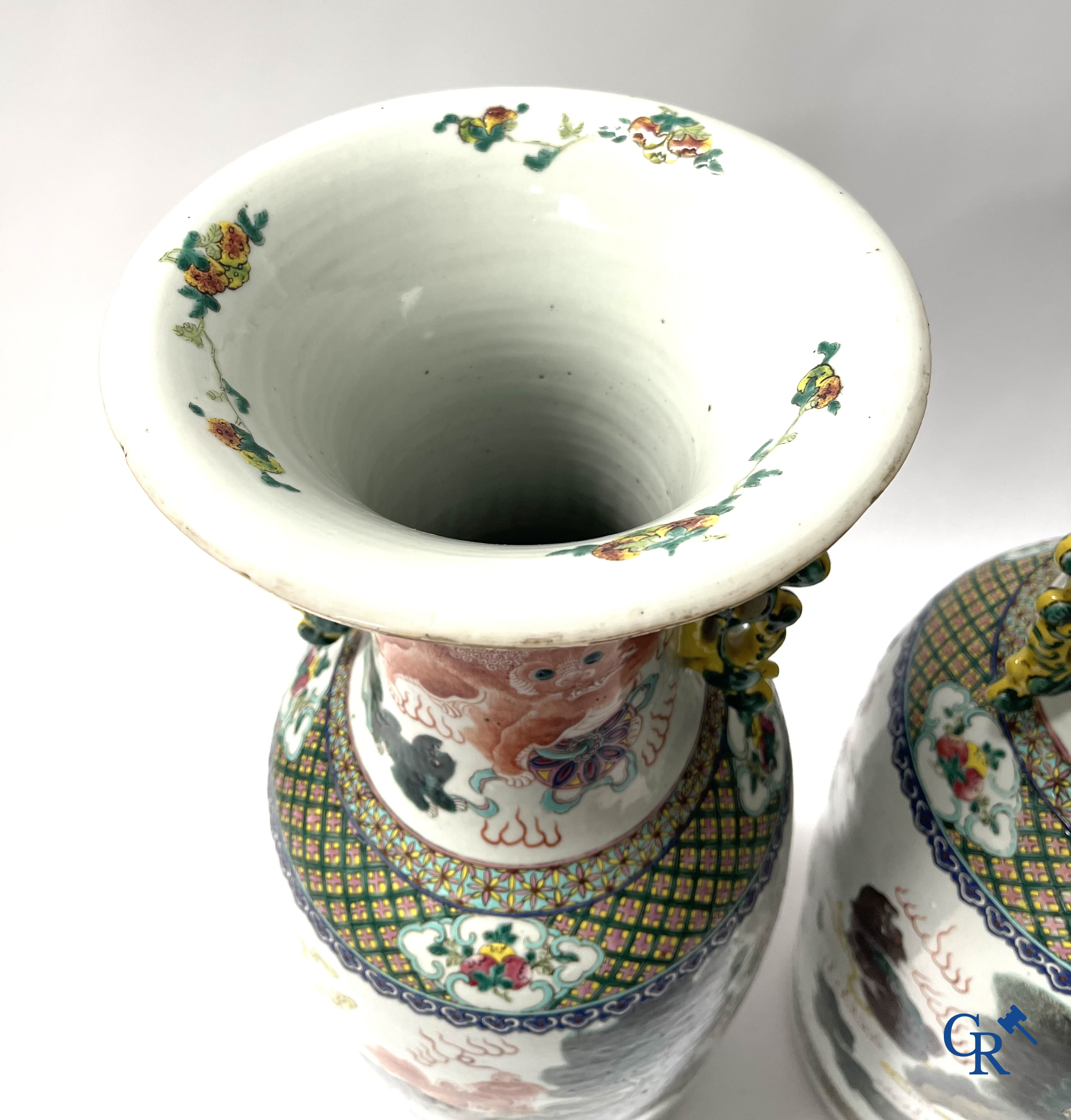 Asian Art, A pair of Chinese famille rose vases with peacocks and Fo dogs. 19th century.