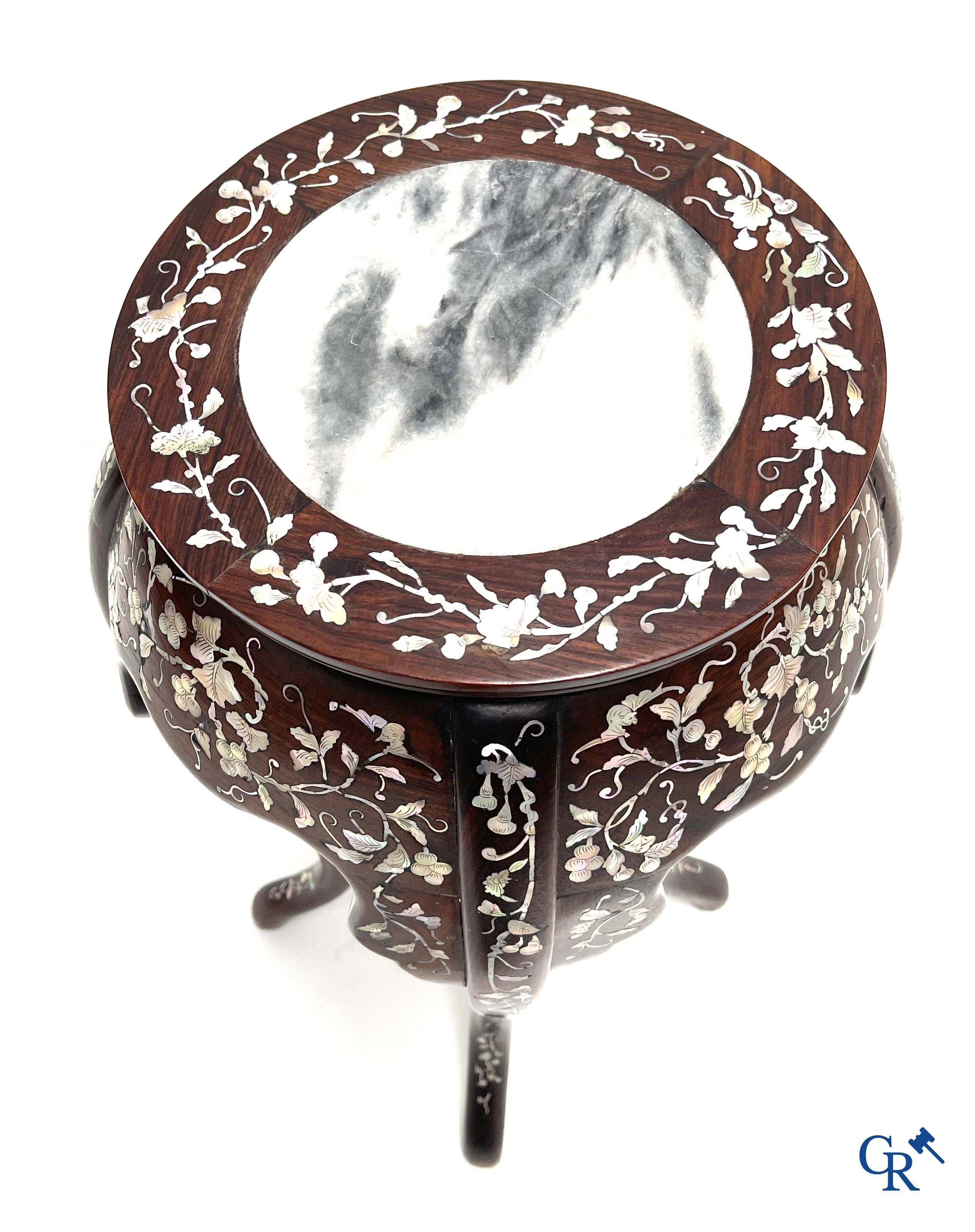 An Oriental wooden pedestal inlaid with mother-of-pearl.