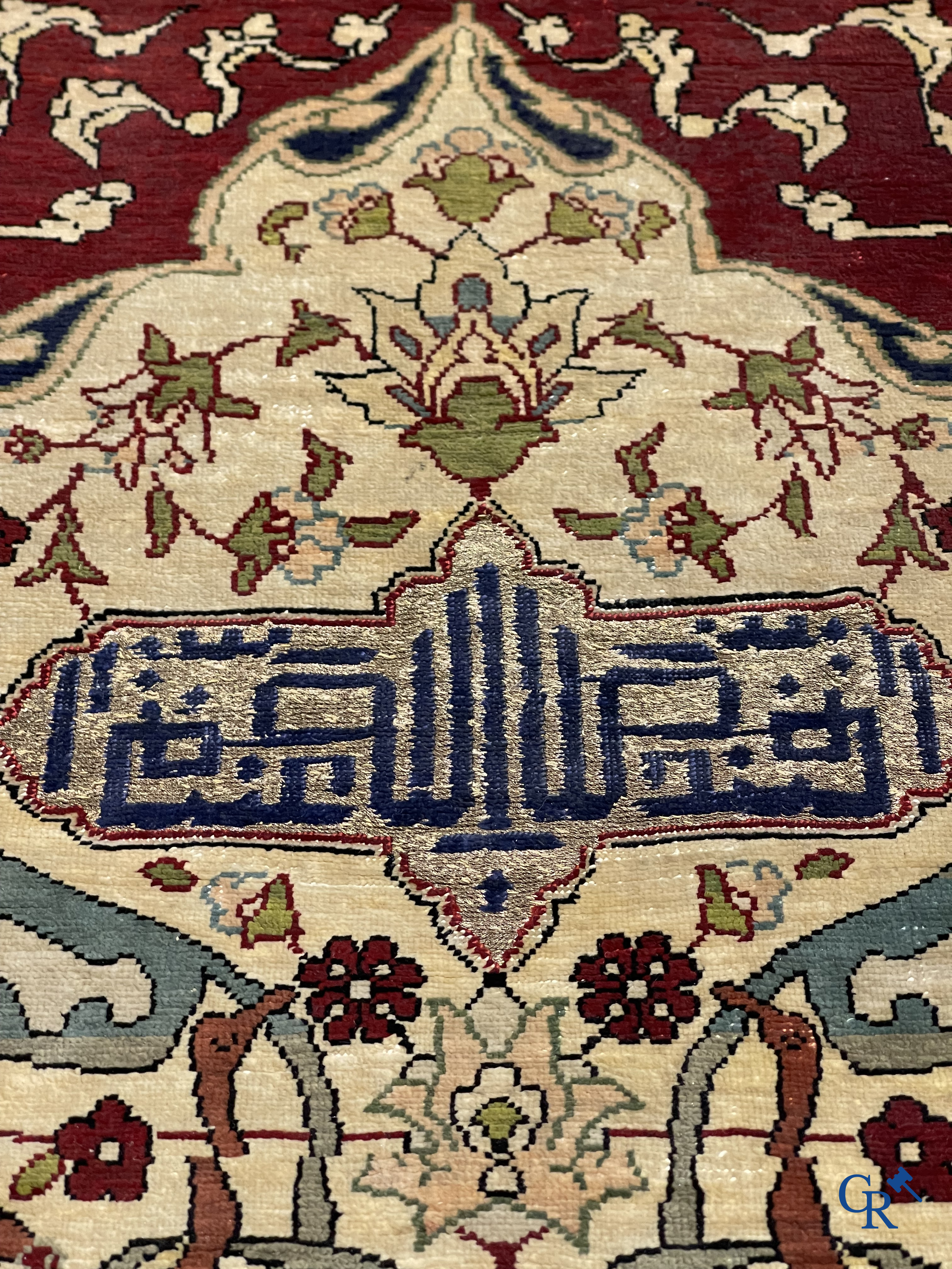 Oosterse tapijten. Een zijden gesigneerd tapijtje met inscripties en bewerkt met gouddraad.