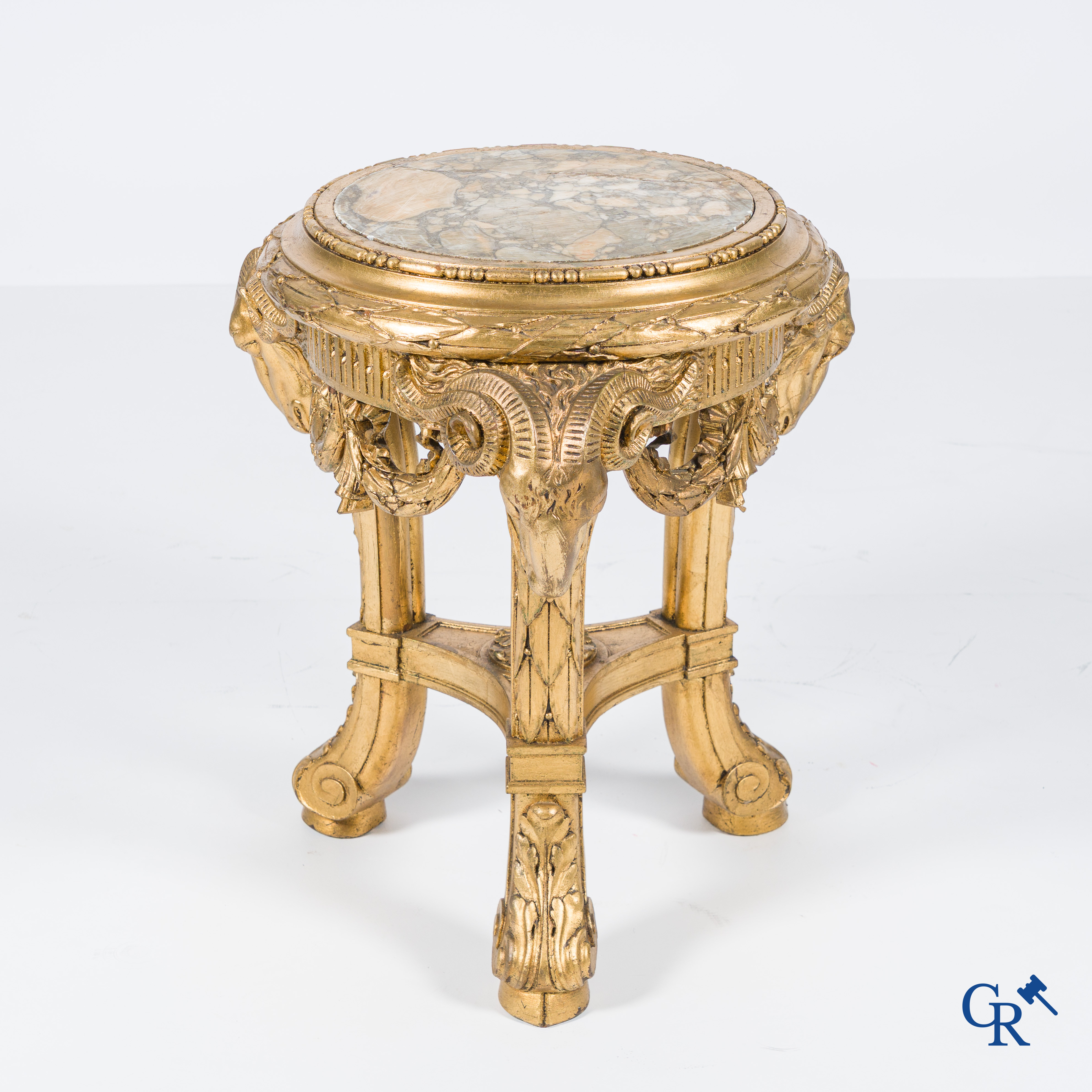 A large wood carved and gilded plinth with ram heads and garlands. LXVI style, circa 1900.