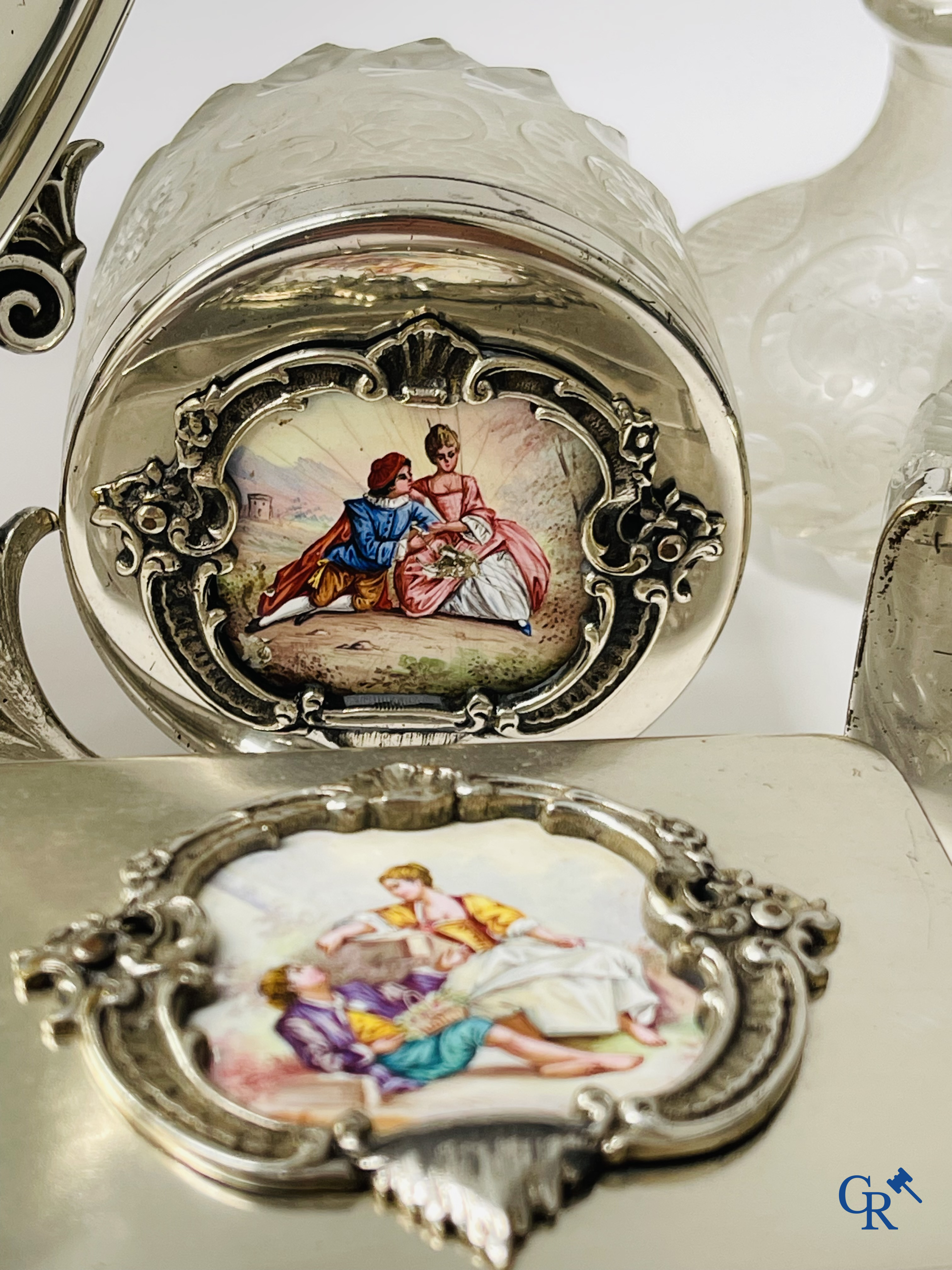 A seven-piece toilet set in silver-plated metal, finely cut crystal and enamelled plaques.