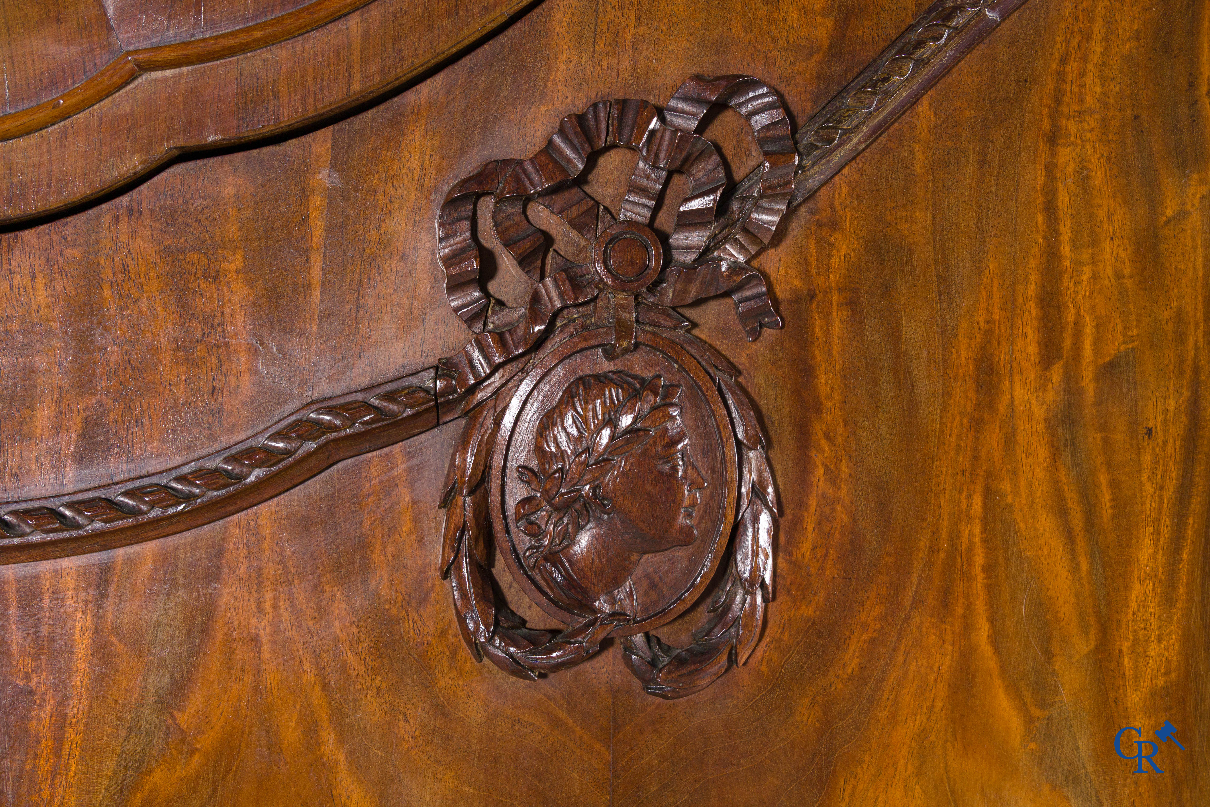 A large mahogany wooden cabinet with 3 drawers and 2 doors decorated with lockets. LXVI style.