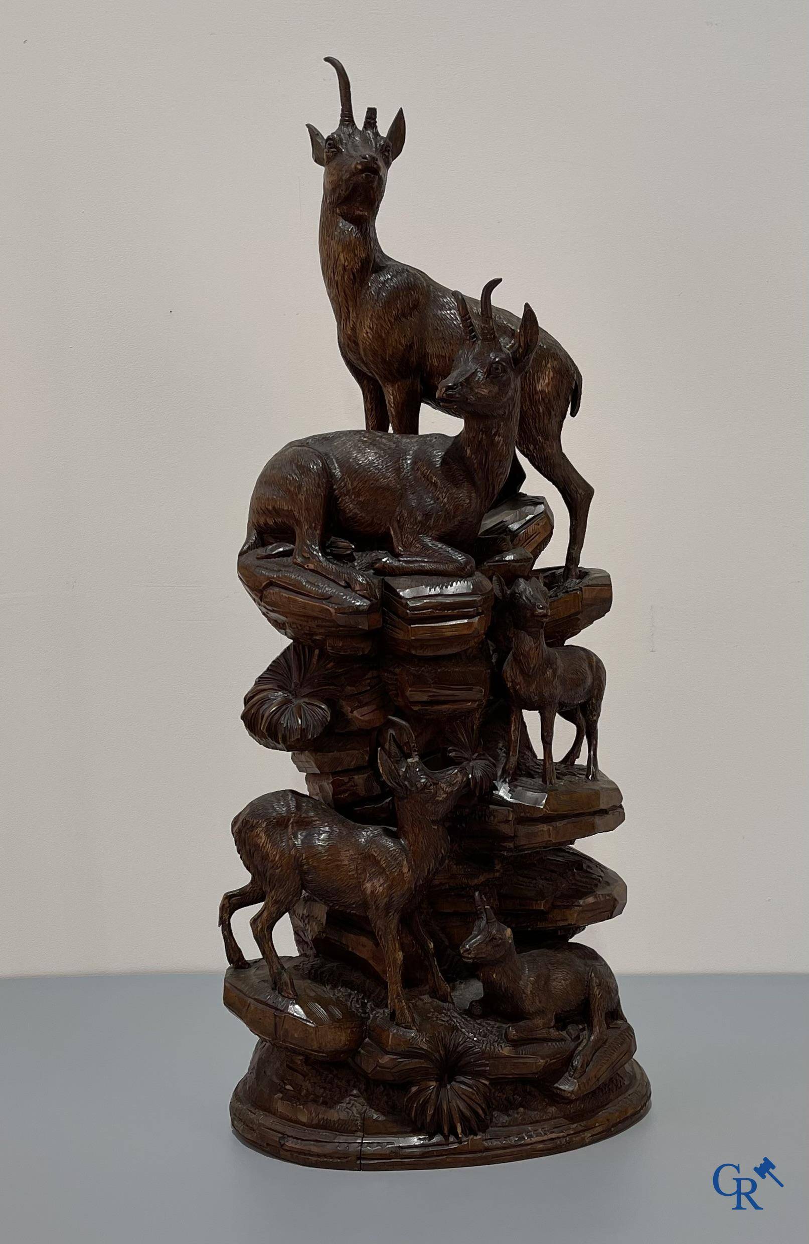Imposing wood sculpture with chamois on a rocky mountain landscape in so-called "black forest". German work, late 19th century.