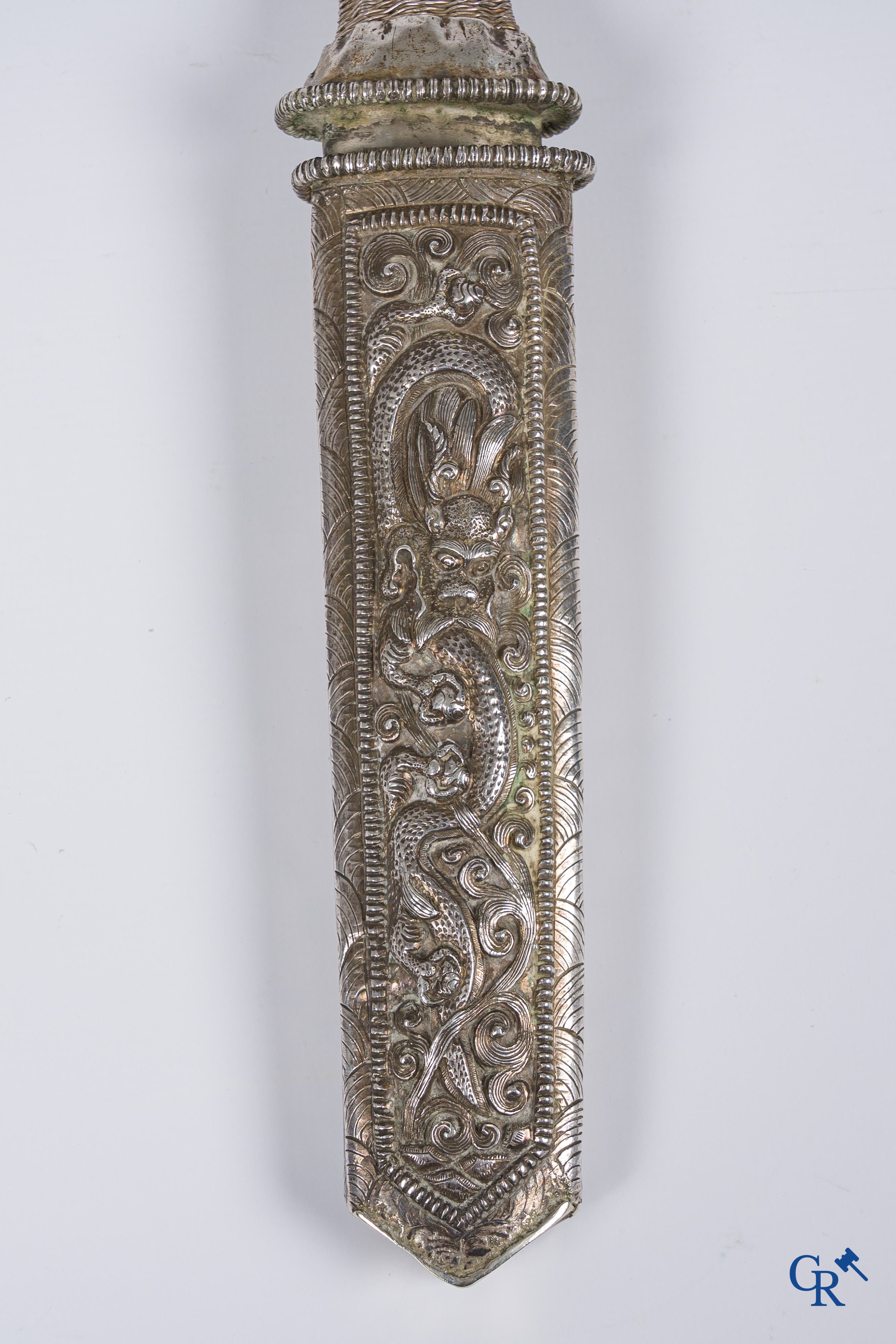 Asian Art, a richly carved silver Tibetan dagger with dragon motif. 19th century.