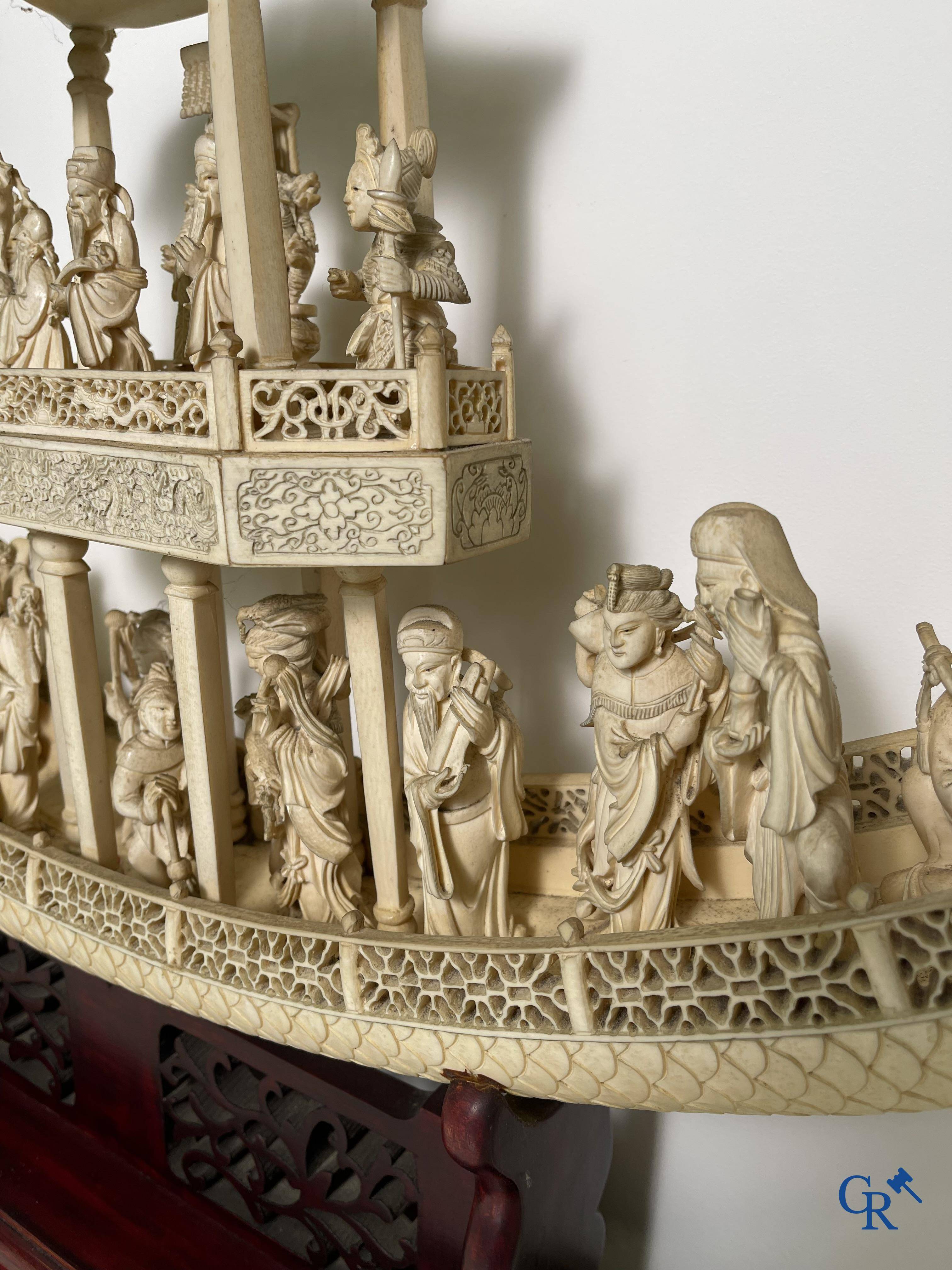 Asian Art: A large Chinese ivory dragon boat on a wooden pedestal. 19th century.