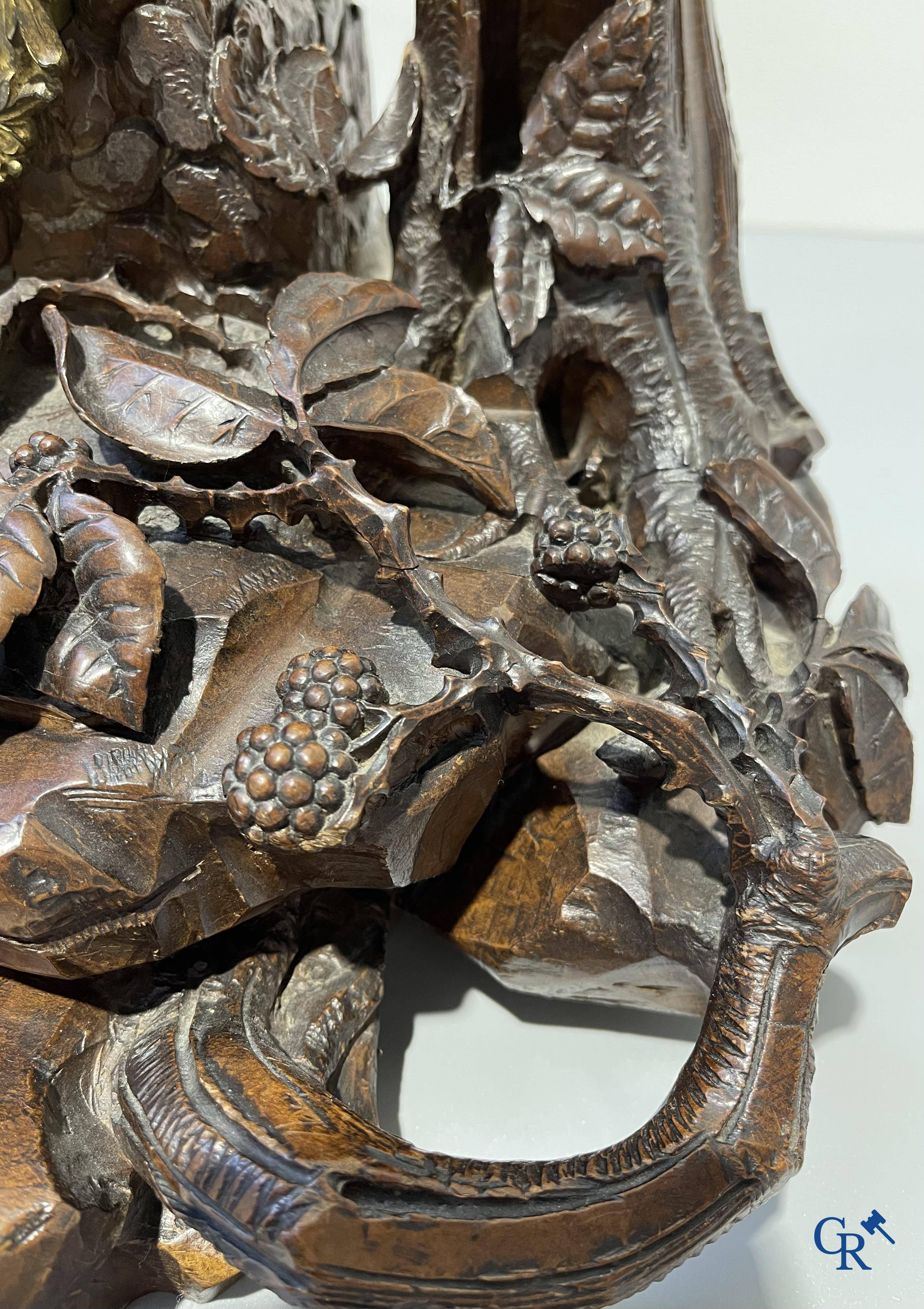 A finely carved walnut clock in so-called "black forest" carving. French work circa 1860-1880.