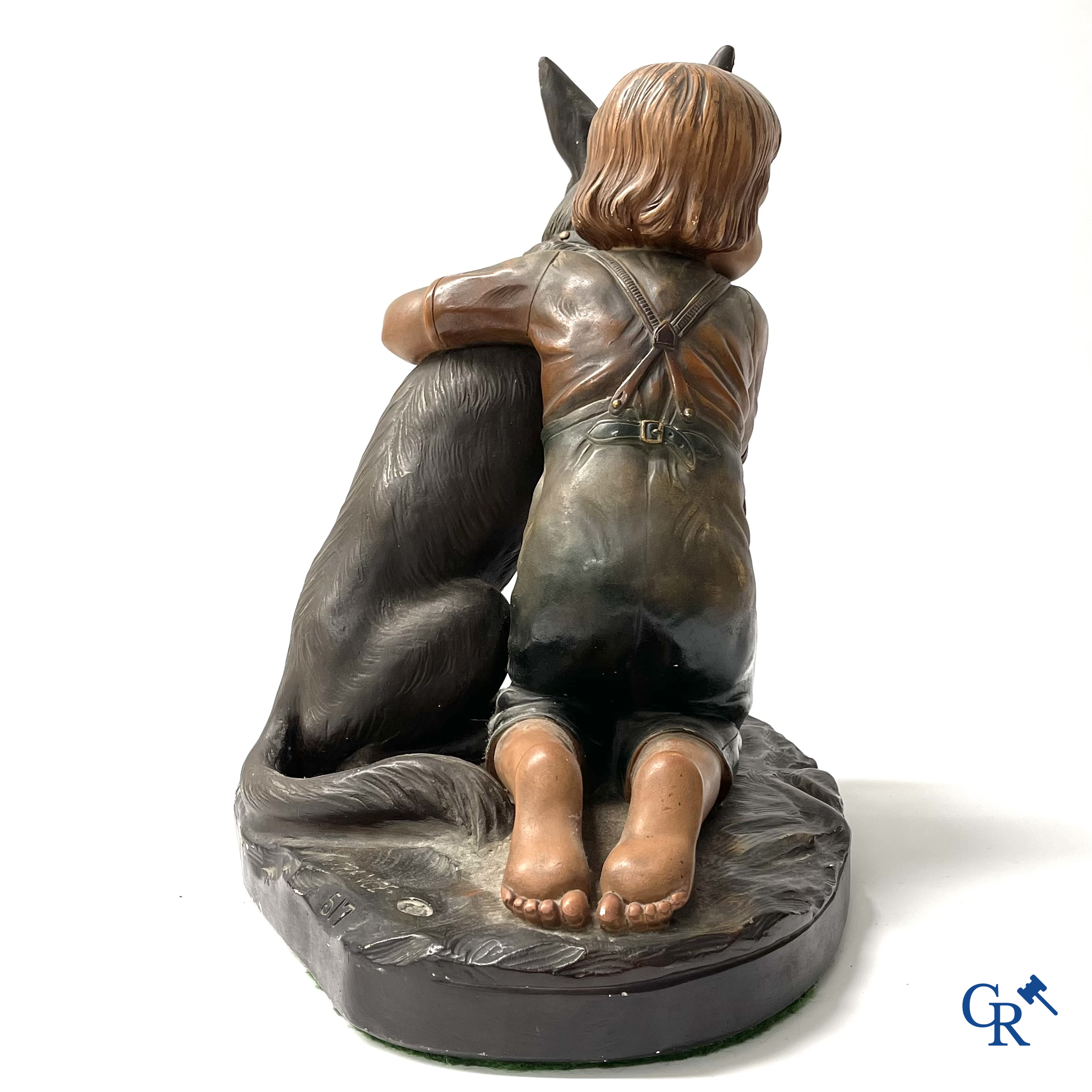 Plaster sculpture, boy with dog and a plaster lamp.