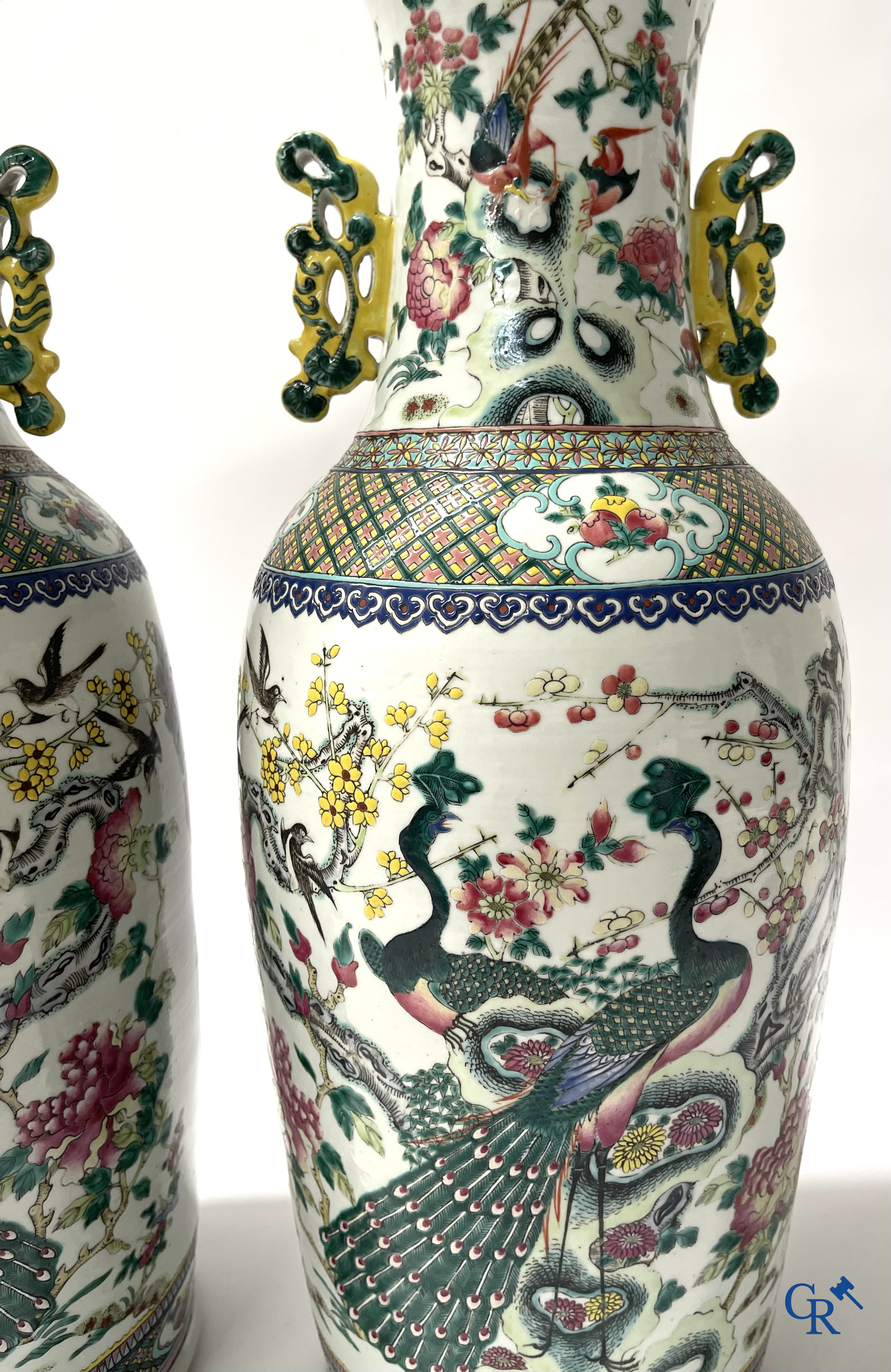 Asian Art, A pair of Chinese famille rose vases with peacocks and Fo dogs. 19th century.